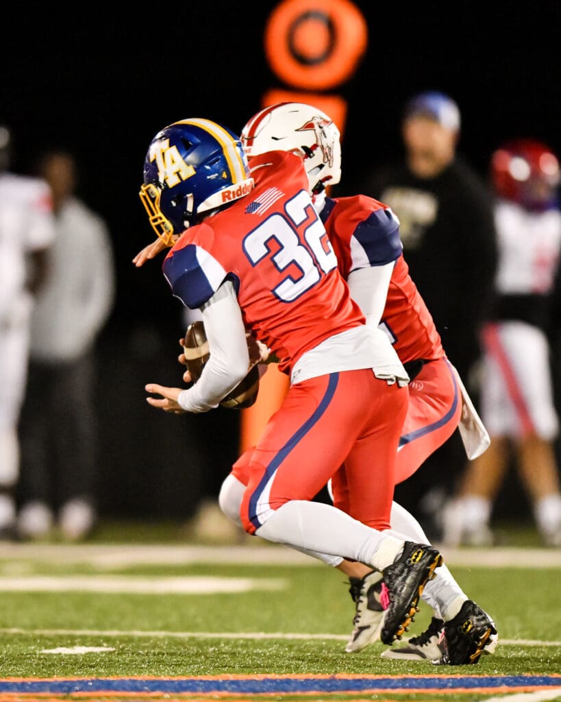 Owen running the ball in the Bowl Game. (Quick Shots Photography)
